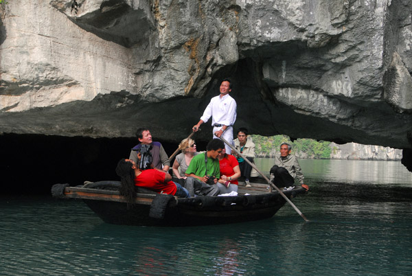 Rowboat passing through Hang Luon Cave into the lagoon