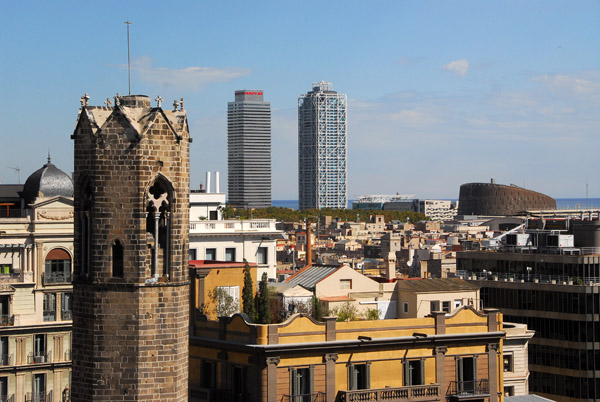 The tower of the Royal Chapel of St. Agatha with the skyscrapers Torre Maphre and Hotel Arts, Villa Olimpico