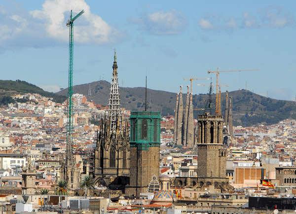 Barcelona Cathedral with the towers of Sagrada Familia in the background from Columbus Monument
