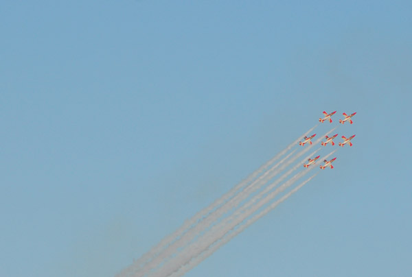 Six-aircraft formation of the Patrulla guila (Eagle Patrol) trailing smoke over Barcelona