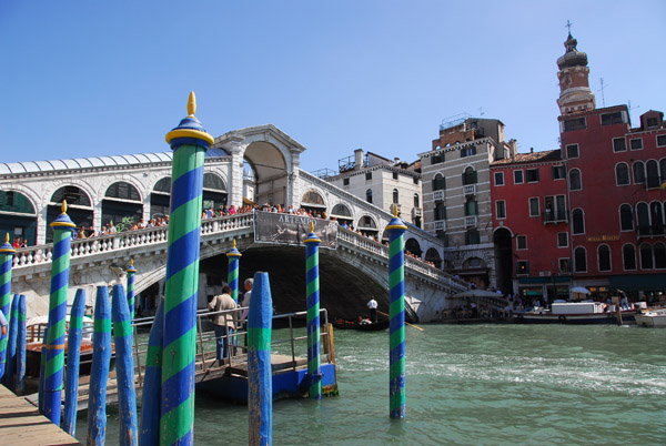Barber-striped poles for tying up gondolas in front of the Rialto Bridge