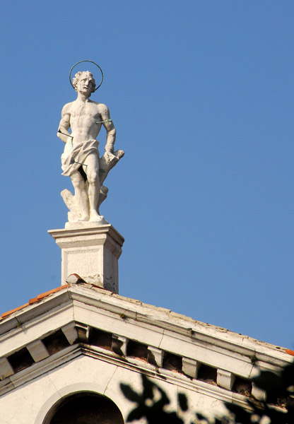 Statue St. Sebastian on top of the pediment of Chiesa di S. Sebastiano, Venice