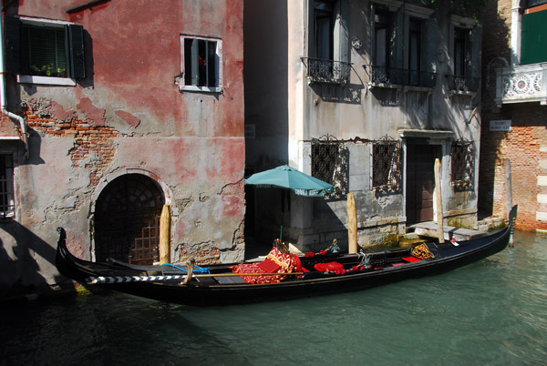 Gondola pulled along side the old houses at Ramo Moro Lin, Venice