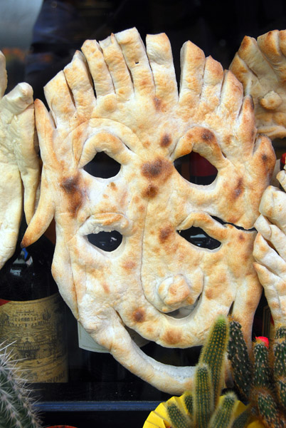 Baked flat bread in the form of a Venetian Carnival mask