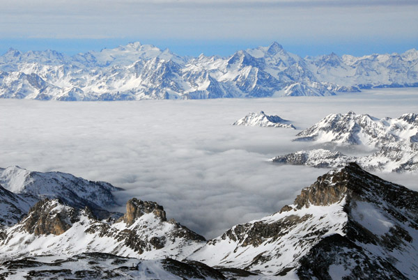 Italian Alps rise above the cloud covered Valle d'Aosta