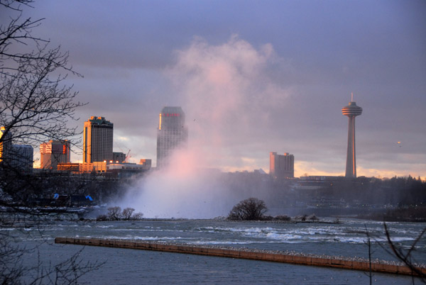 Mist of Horseshoe Falls from upstream with Niagara Falls, Ontario in background, Skylon Tower
