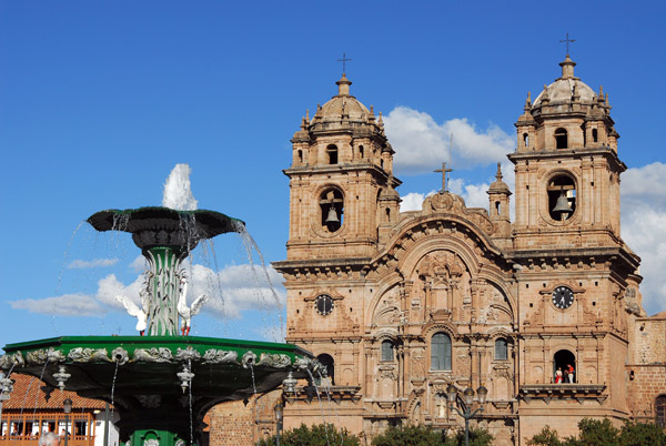 Fountain in the center of Cusco's Plaza de Armas with Jesuit Church