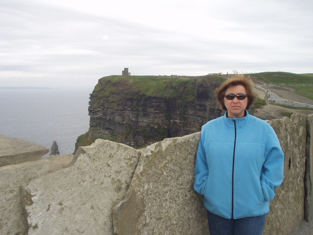 Cliffs of Moher.  You can detect, from Lisas expression, that the wind is blowing about 40 mph at the moment.