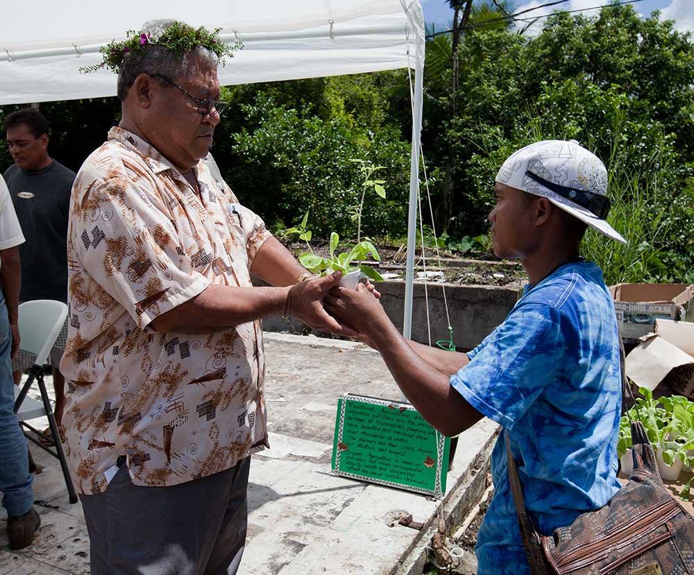 Receiving one of the many seedlings given out by the extension service. IMG_7935.jpg