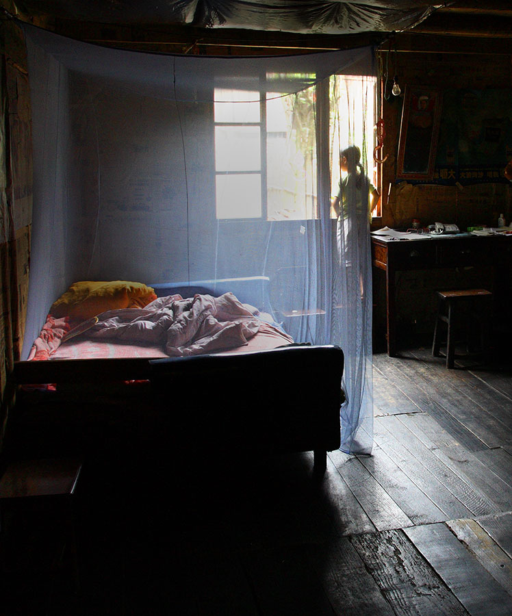 the netted bed. Remote village, China. 2006