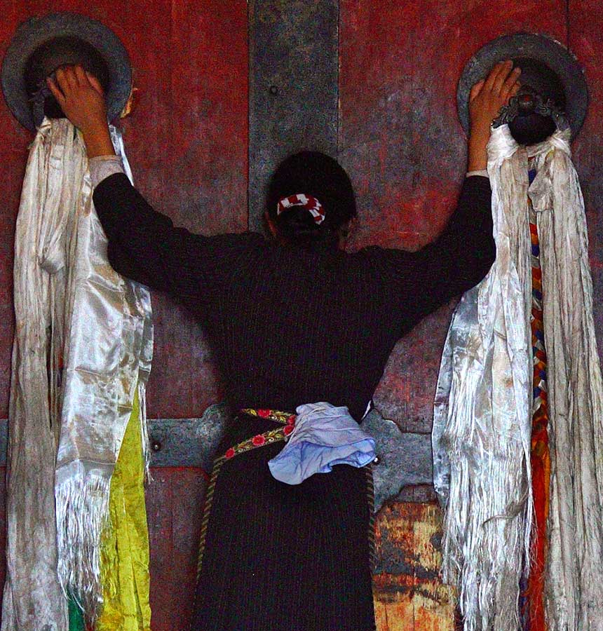 Praying, monastery doors.