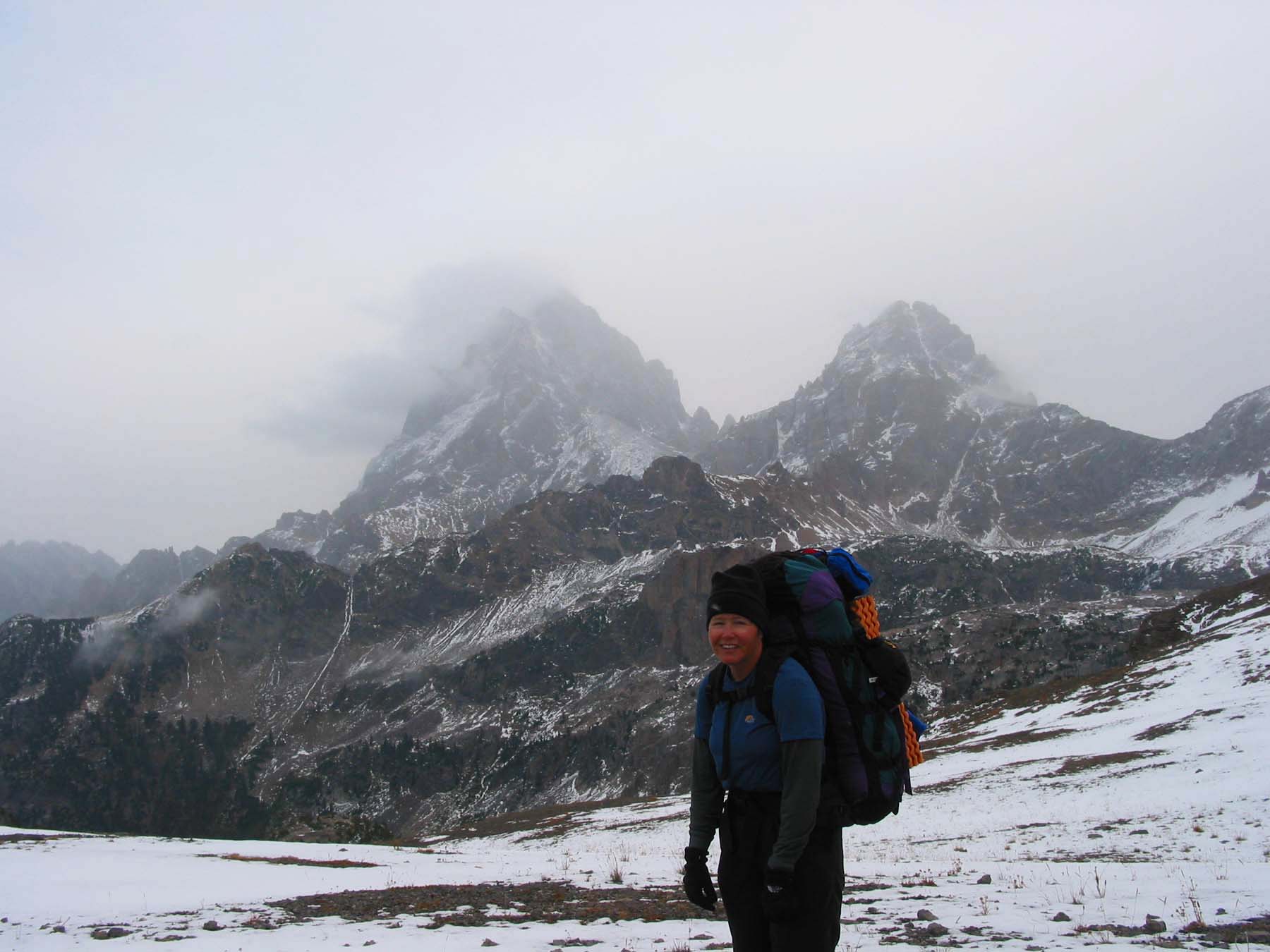 Carol at the top of the pass, with Grand and Middle Teton