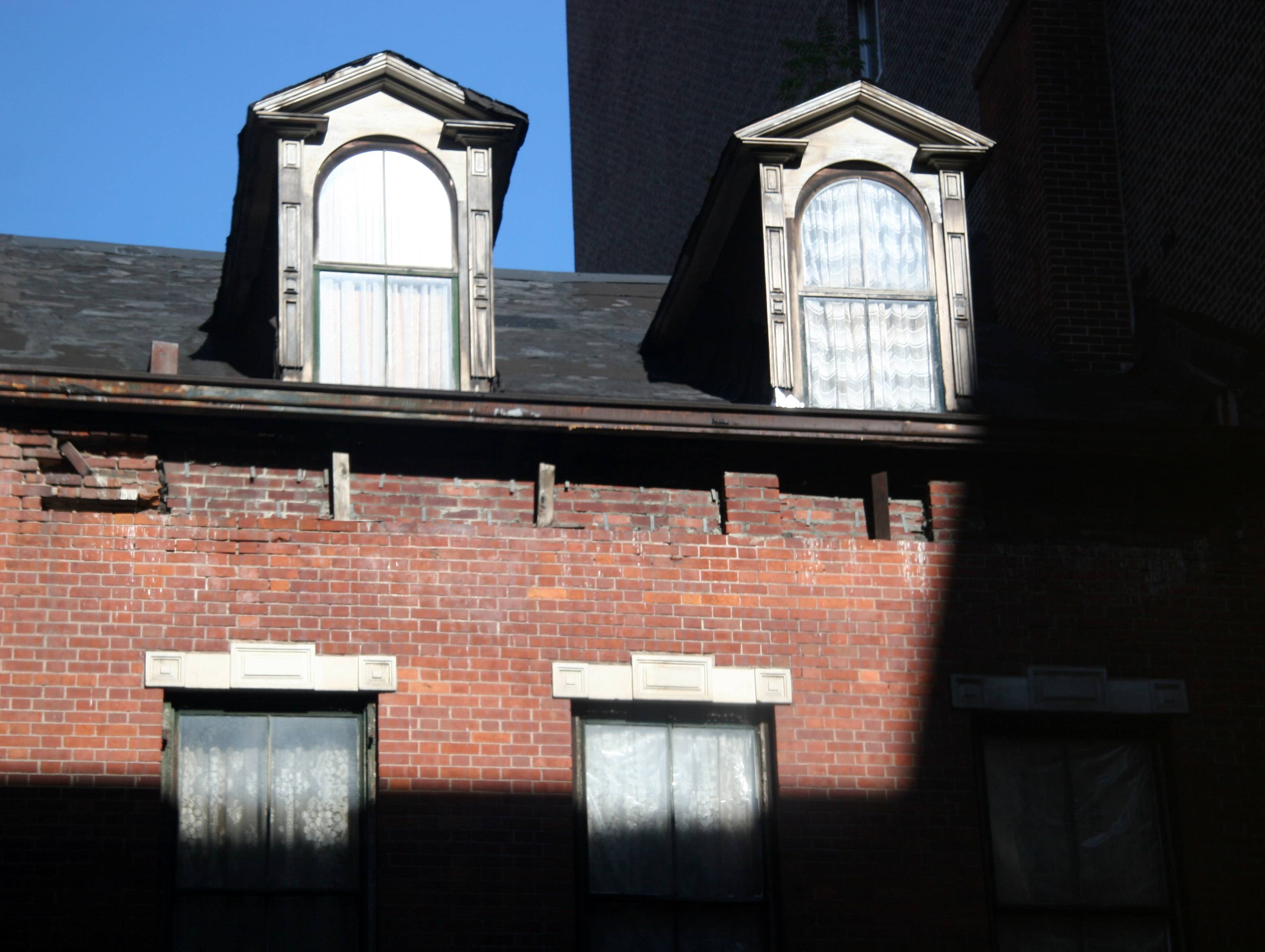 Window Reflection - Rising Sun on Two Gables