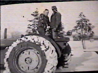 Walt and Opie on John Deer tractor taking hay to cows during winter.jpg