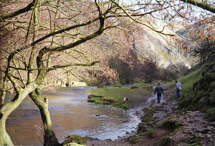 Morning walkers. The River Dove. Dovedale in the Peak District , UK