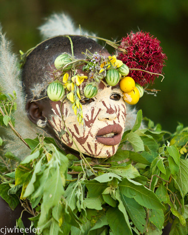 We had been spotting these red flowers on the side of the road and were happy to see it up close in this headdress.