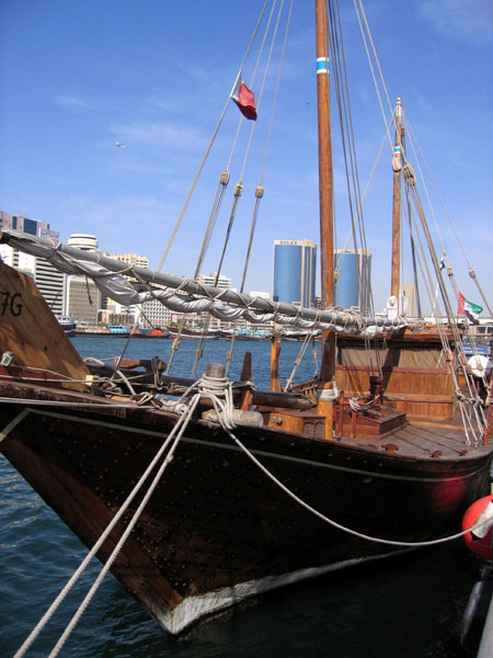Traditional wooden dhow tied up along Dubai Creek