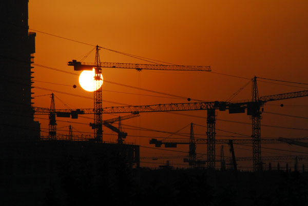 Construction cranes at sunset, Dubai