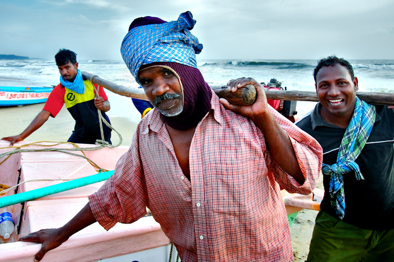 A trio carrying the boat