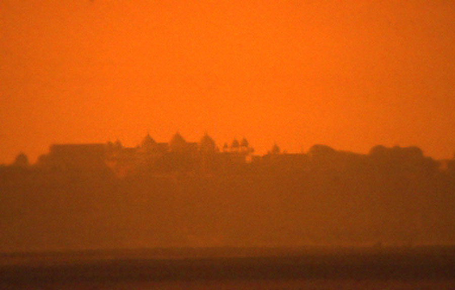 Agra Fort in the sun setting distance.