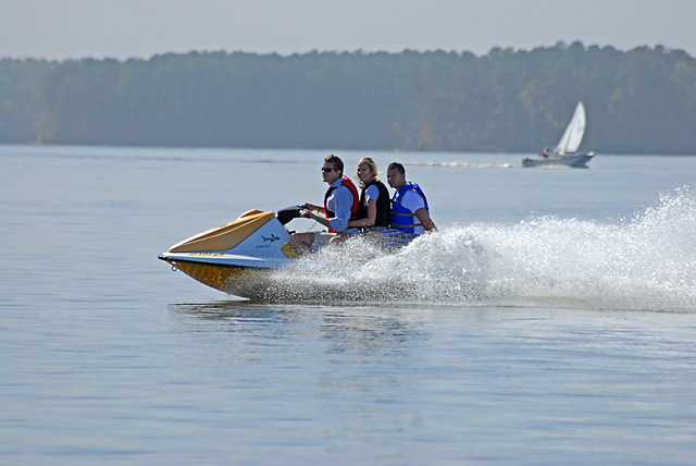 There were a lot of people playing at the lake today.