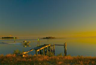 small boat returns to Horseshoe Beach from a day on the gulf