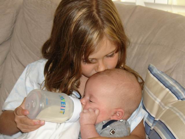 Libby feeding her brother