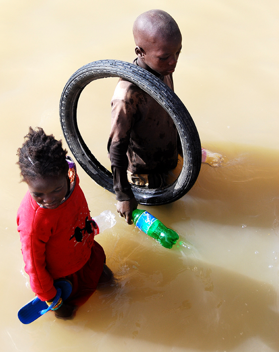 One Girl, One Boy, a Flip-flop, Three Bottles and a Tire