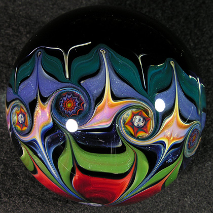 Two different types of millifiori snaps decorate the twists on the side of the marble.  Made in 2007.