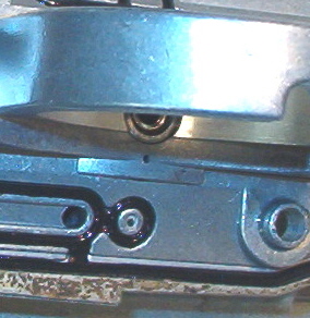 Two small passages flow fuel from the pilot jet, however, only the lower opening is metered by the fuel screw