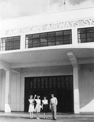 1942 - Miss Lutrelle Conger (waving) and co-workers outside Pan American Airways System hangar