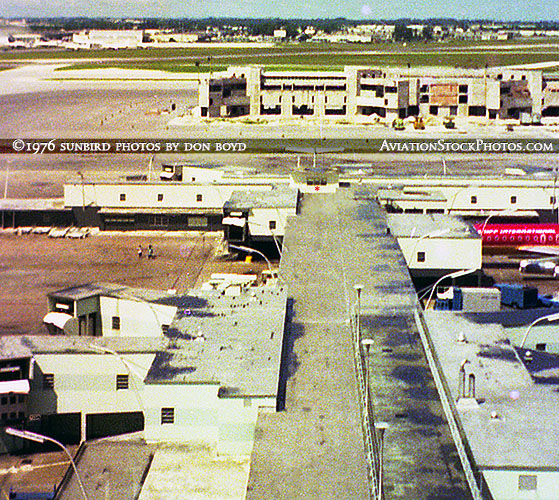 1976 - view of old Concourse E and the new E-Satellite under construction
