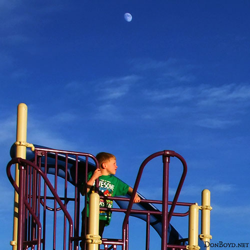 November 2012 - Kyler on the playground with the moon rising in the east at Peterson Air Force Base, Colorado