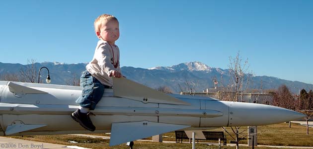 December 2006 - Kyler sitting on old Army missile with Pikes Peak in the background