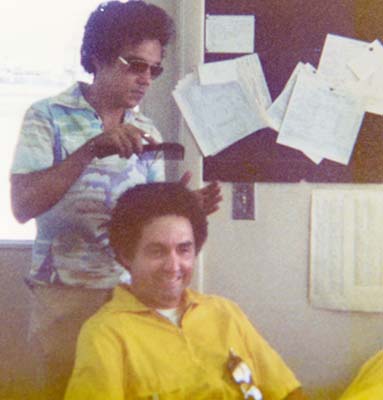 1976 - DCAD Airfield Clerk Jose Joe Dominguez enhancing the Afro on Agent Bill Stubbs at GAC