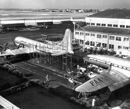 1950 - American Overseas B-377 N90941 and Constellation being painted in Pan American paint scheme at Miami