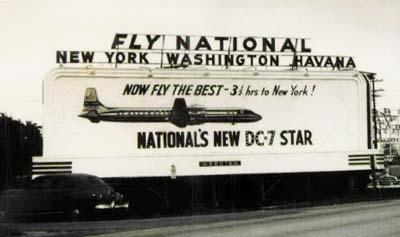 1955 - National Airlines billboard in Miami advertising new DC-7 Star service to New York, Washington and Havana