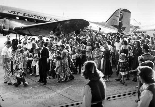 1950s - Santa arriving on EAL DC-3 N15567 to greet children of Eastern employees