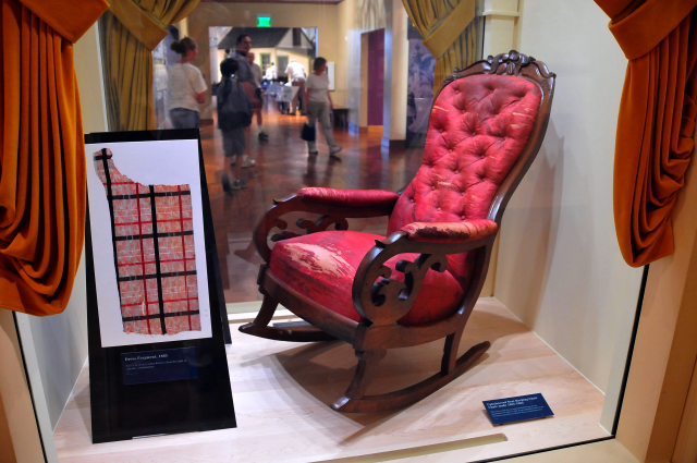 Rocking chair on which Abraham Lincoln was assassinated in 1865. Hair oil & blood stains not positively identified as Lincolns.