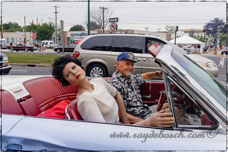 Old man with his doll in his T-Bird