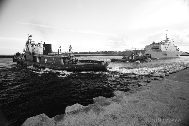 tugs coming about; USS Freedom arriving in port