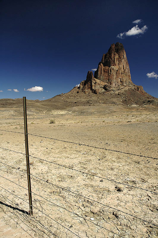 Agathla Peak is an eroded volcanic neck consisting of volcanic breccia cut by dikes of an unusual igneous rock called minette.