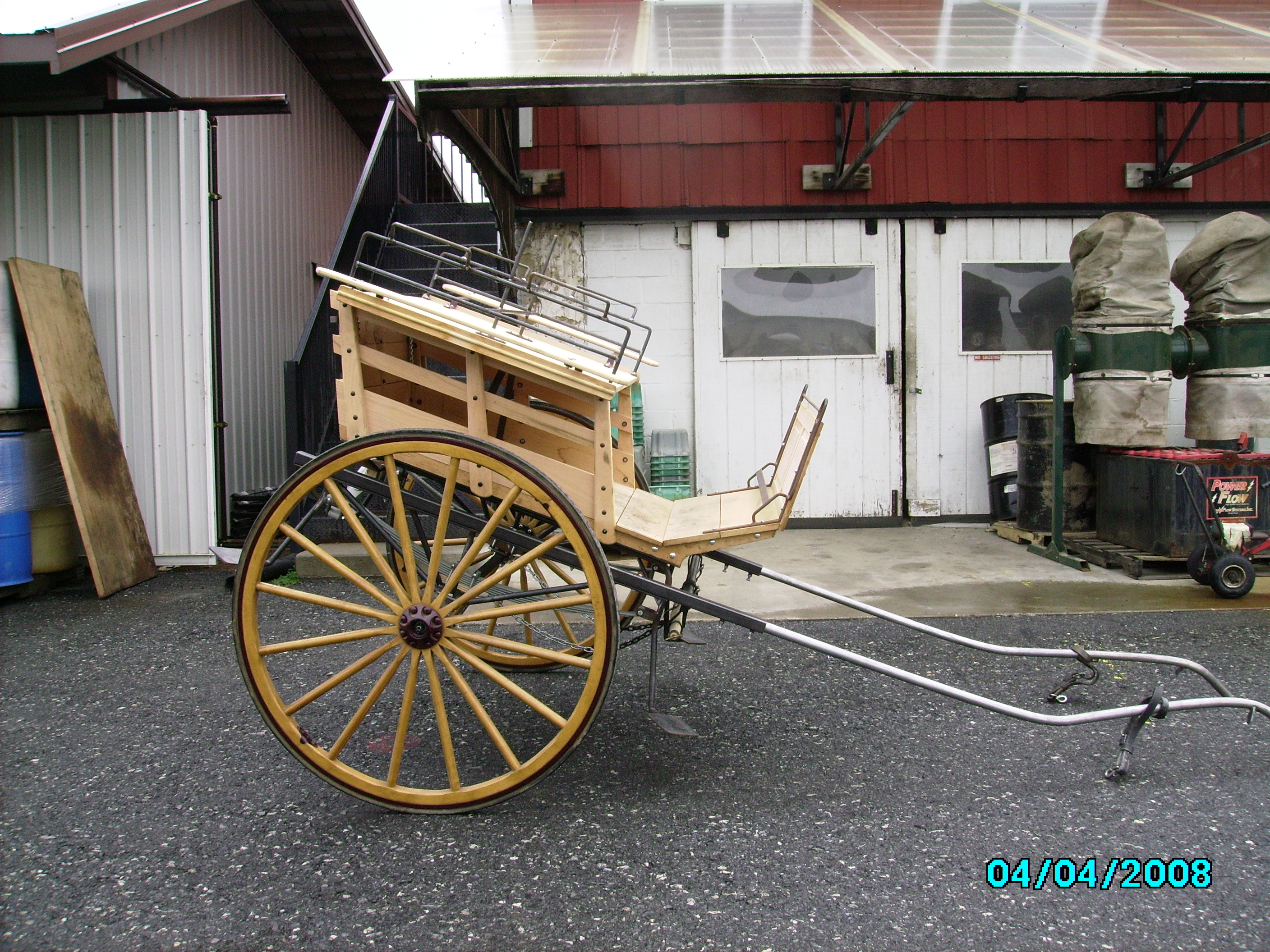 new cape-type cart under construction at carriage machine shop - converts from shafts to pole