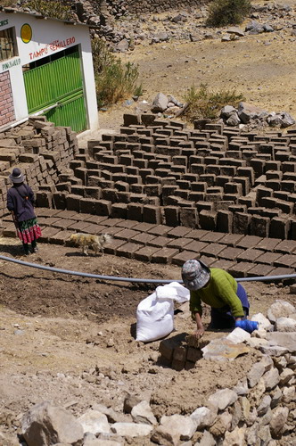 Getting the hands dirty making mud bricks