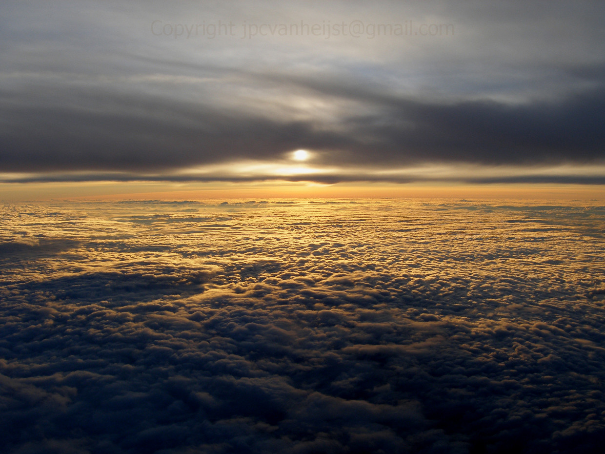 Sunset over the clouds