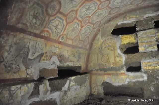 Frescos showing geometric decorations on vault and citron (ethrog) on far wall.