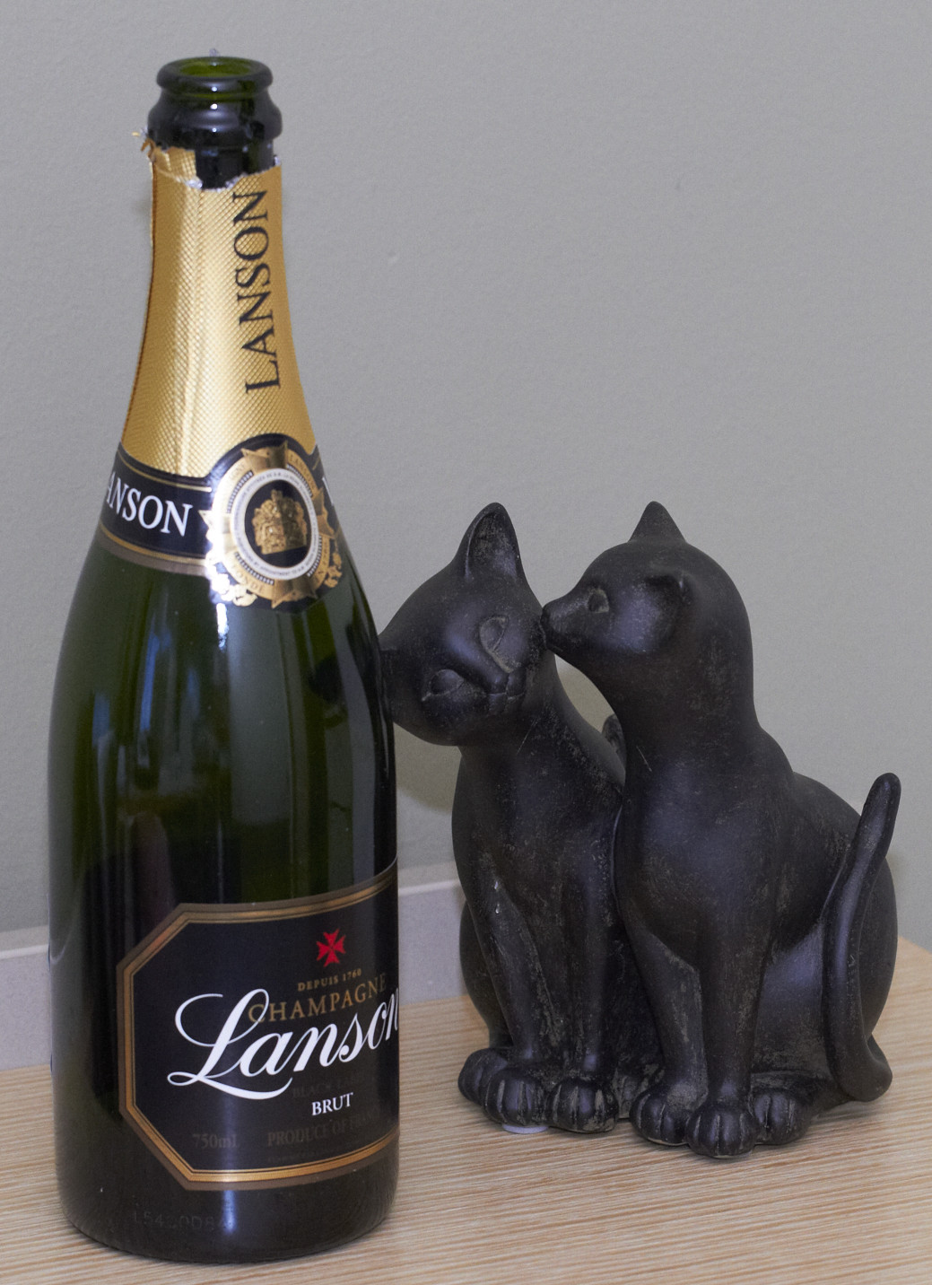 empty bubbly bottle and cats