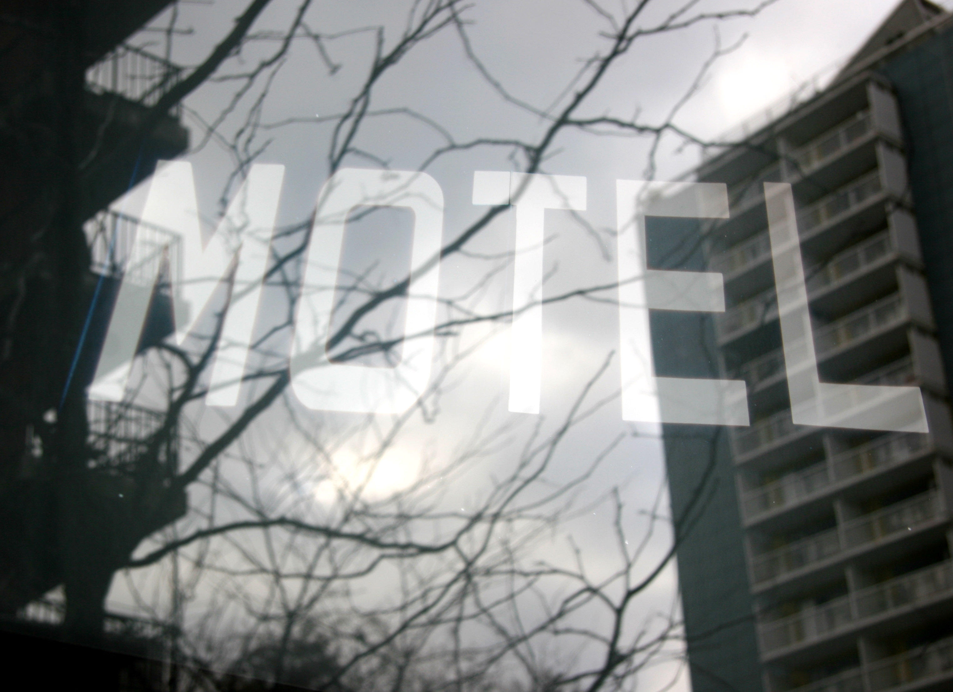 Motel Sign  with Window Reflection of LaGuardia Place Residences