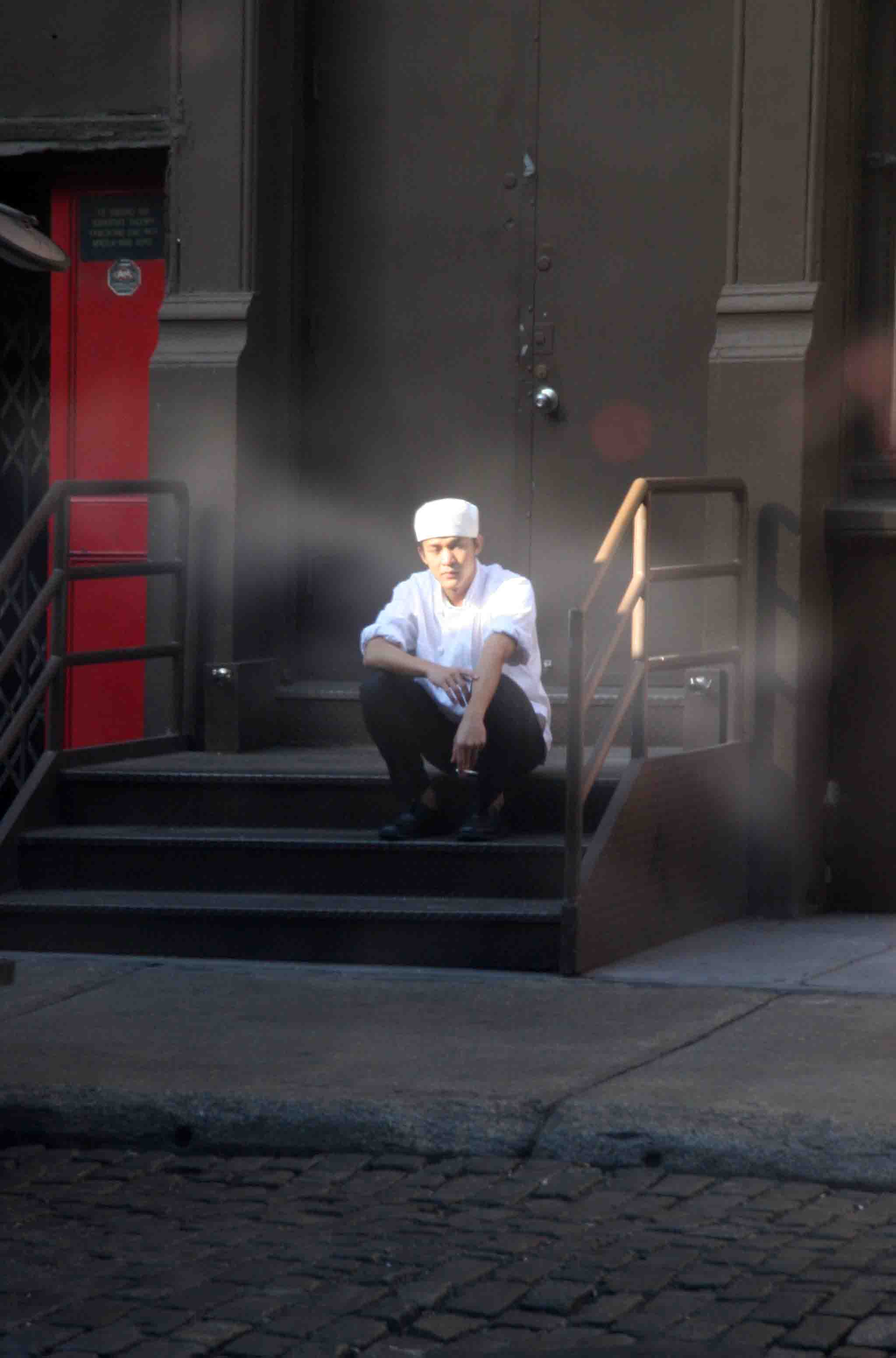 Restaurant Worker Taking a Break Reflected in a Window