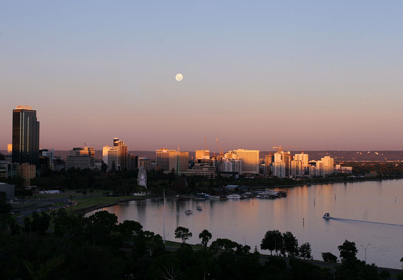 Sun setting as gibbous moon rises over Perth Water